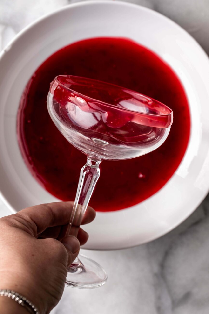 glass with cornstarch and cranberry juice for Vampire's Kiss Cocktail.