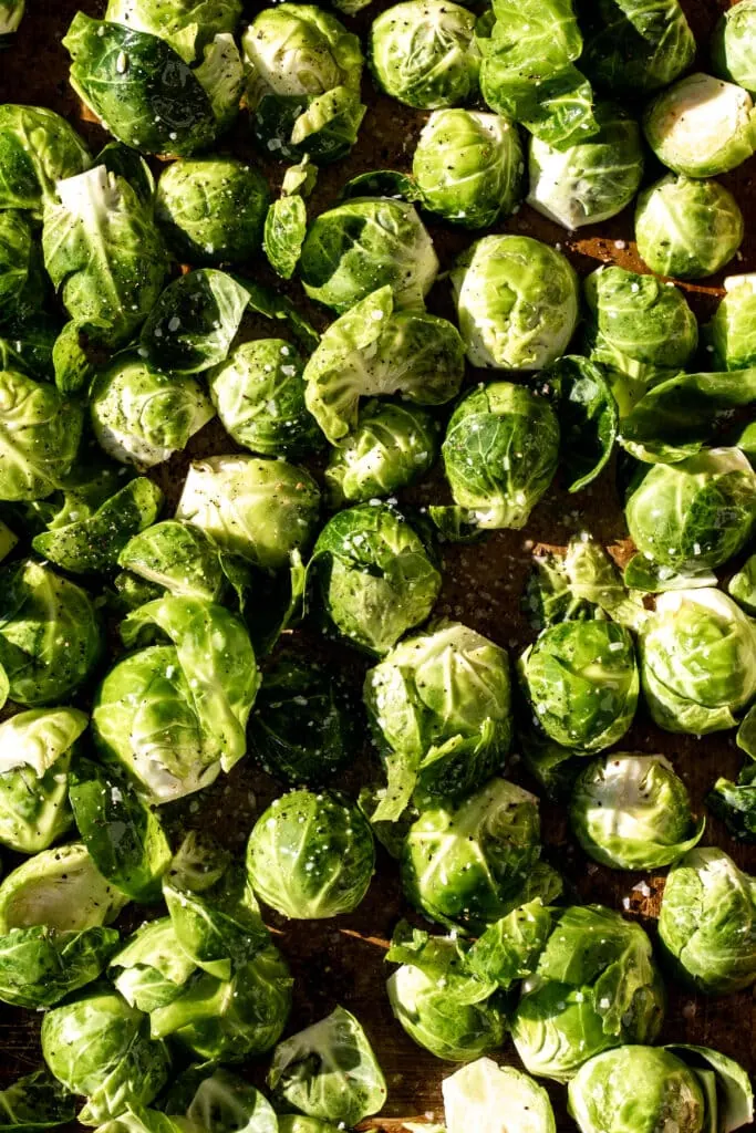 trimmed and halved brussels sprouts tossed in olive oil with salt and pepper