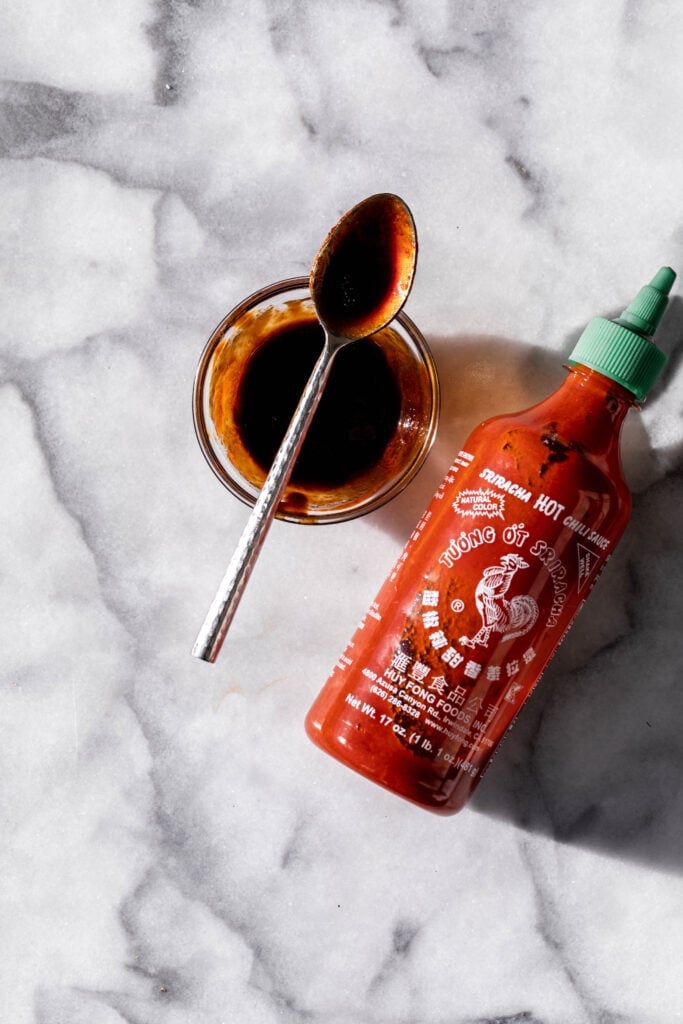 balsamic sriracha sauce stirred in bowl.