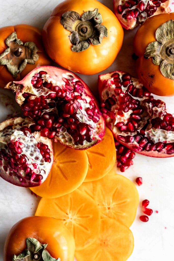 sliced persimmons and pieces of pomegranate. 