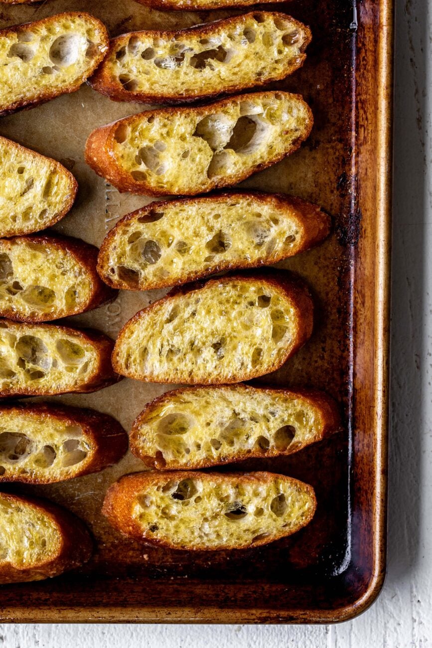 dipped bread in oil on baking sheet.