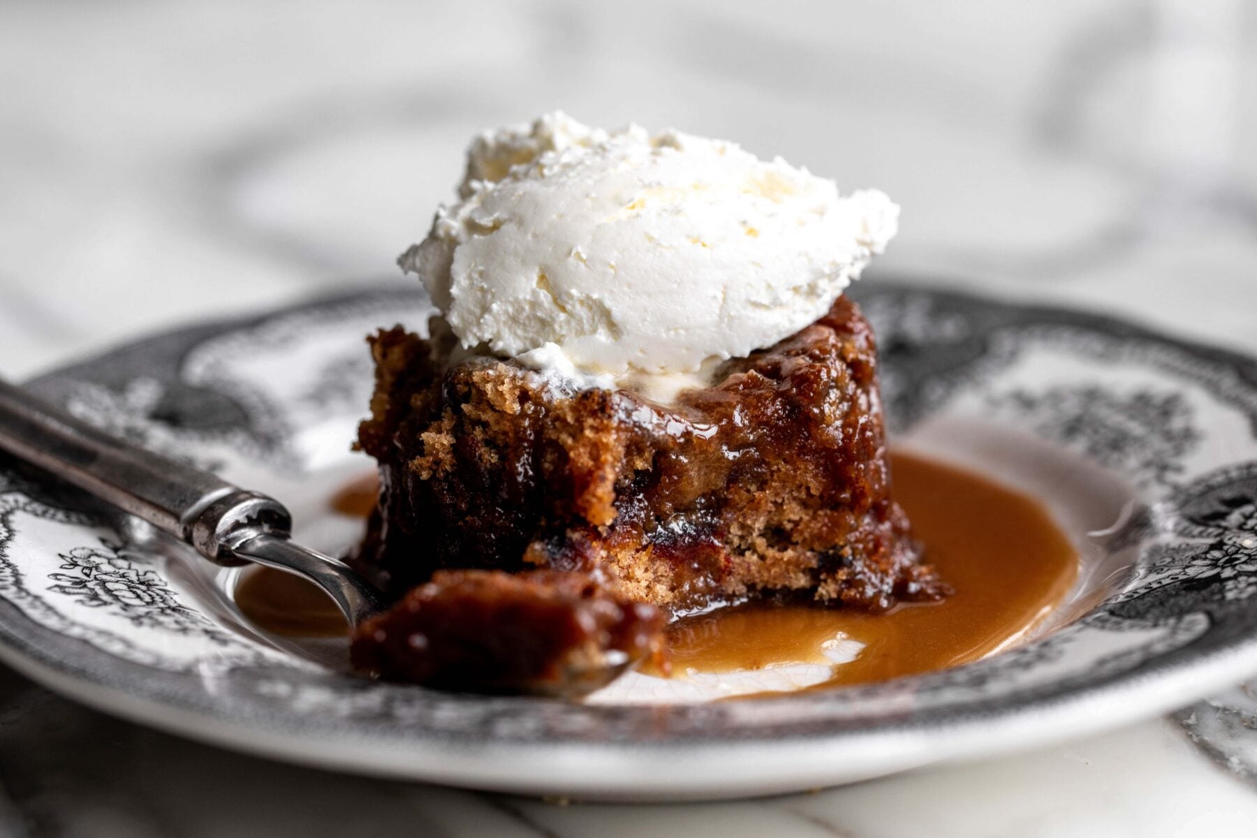 sticky toffee pudding topped with mascarpone whipped cream.