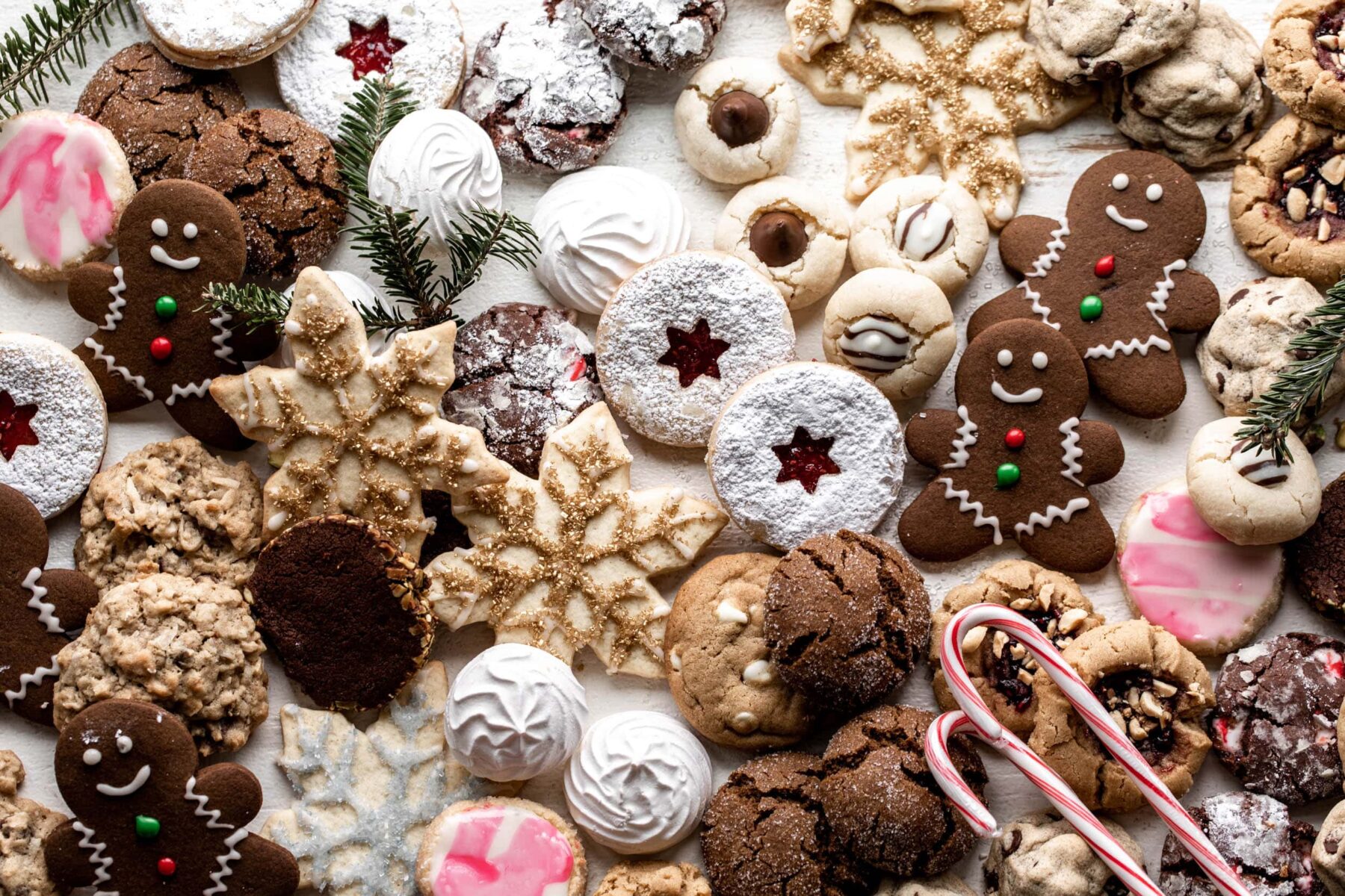 assortment of christmas cookies with candy cane and gingerbread men.