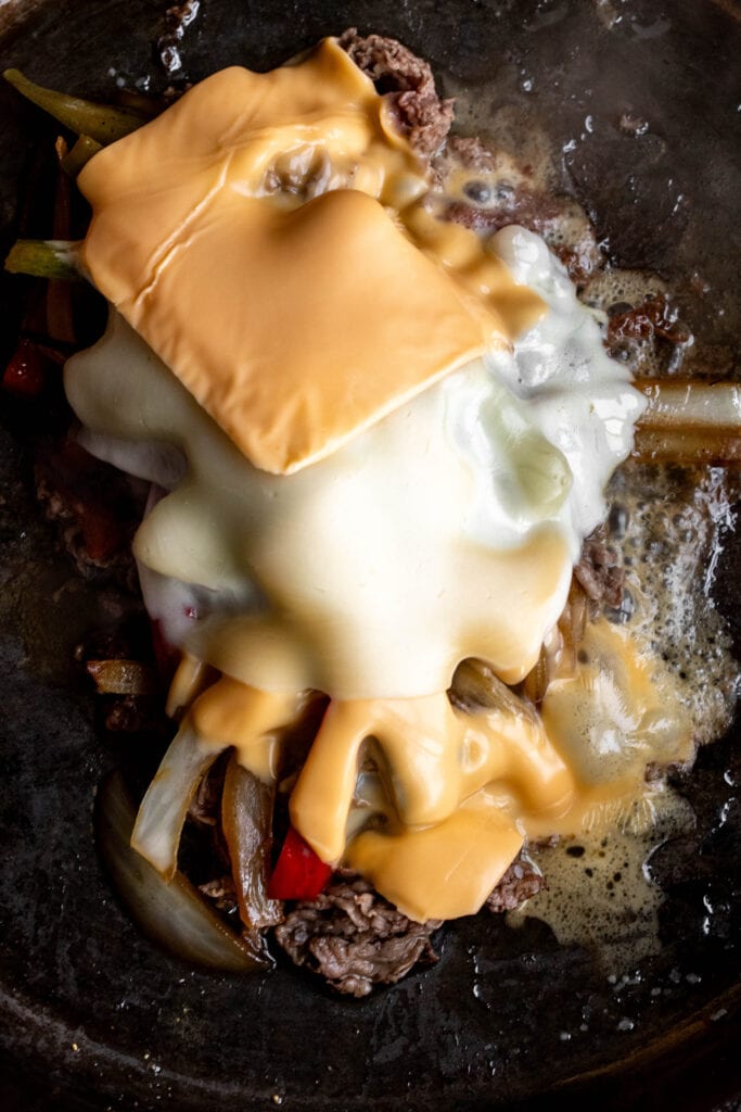 cheesesteaks topped with american and provolone cheese