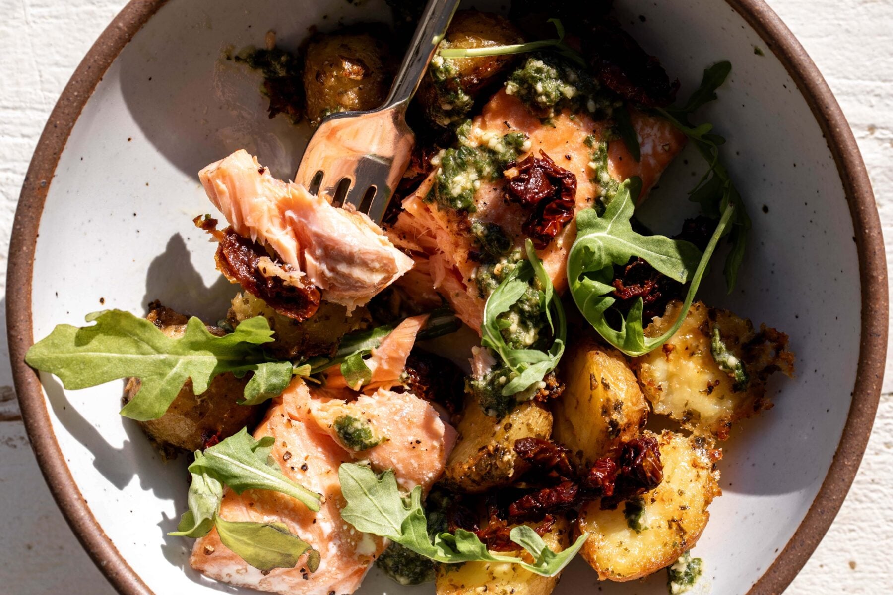 Roasted Salmon with Pesto Potatoes and sun-dried tomatoes.