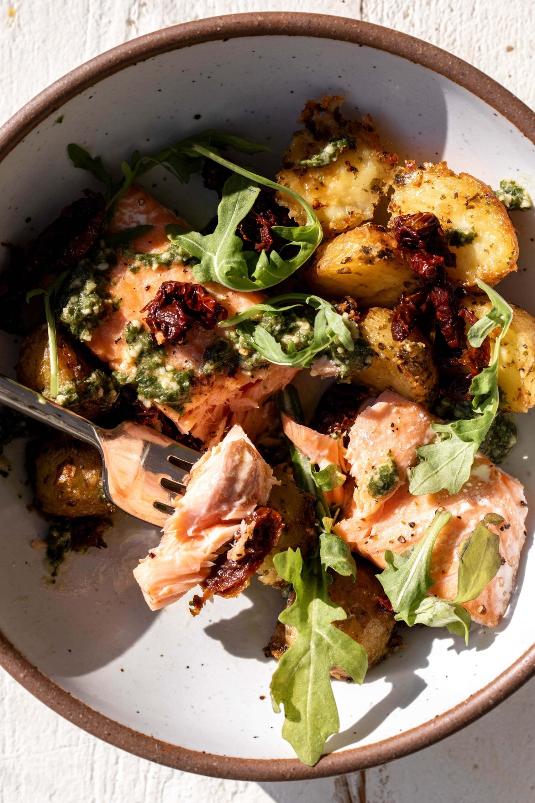 Roasted Salmon with Pesto Potatoes and sun-dried tomatoes.
