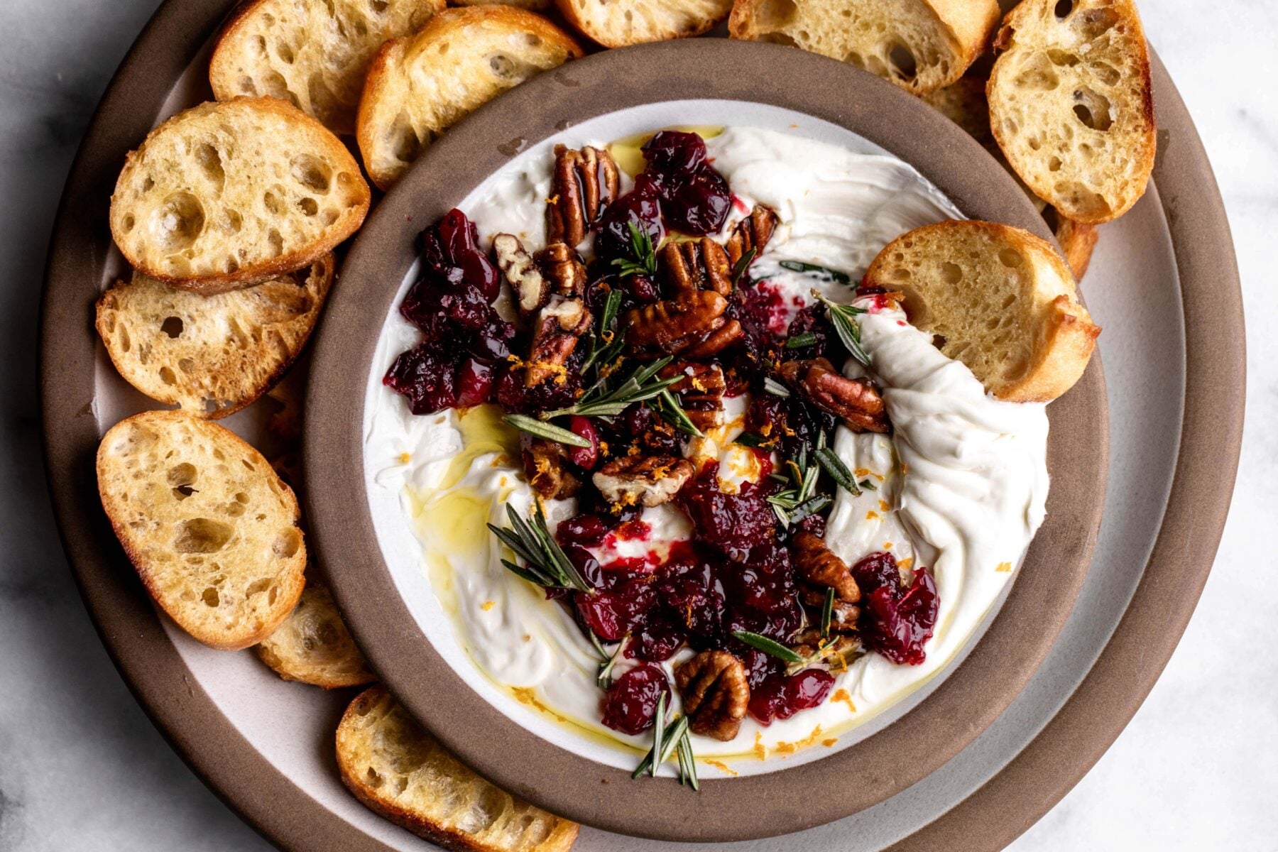 whipped goat cheese with cranberries pecans and rosemary with crostini.