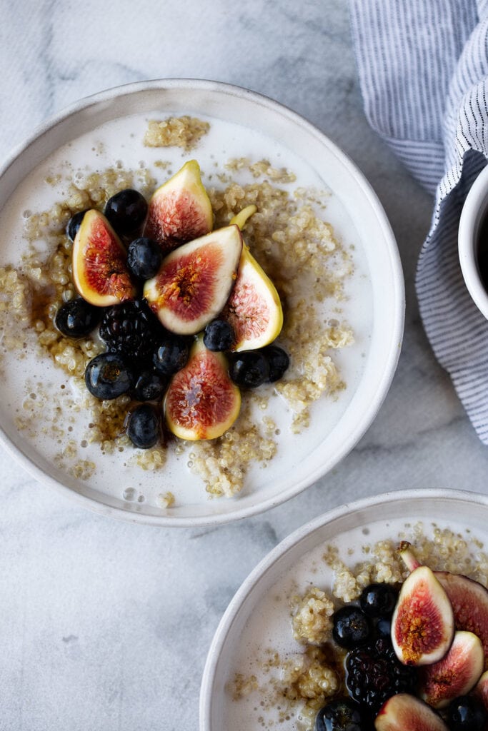 Coconut Quinoa Oatmeal topped with blueberries blackberries and figs.