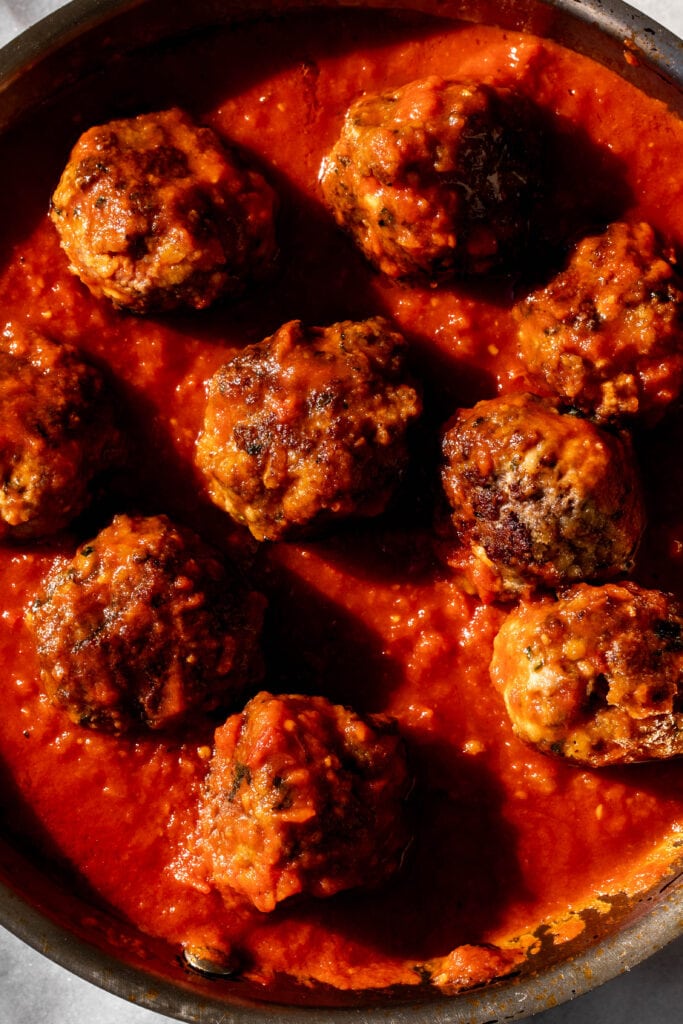 meatballs simmered in tomato sauce.
