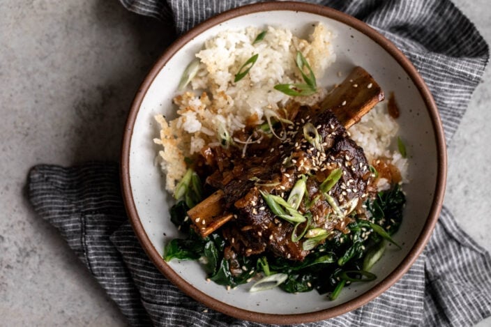 Braised miso ginger short ribs over crispy rice and sautéed spinach.
