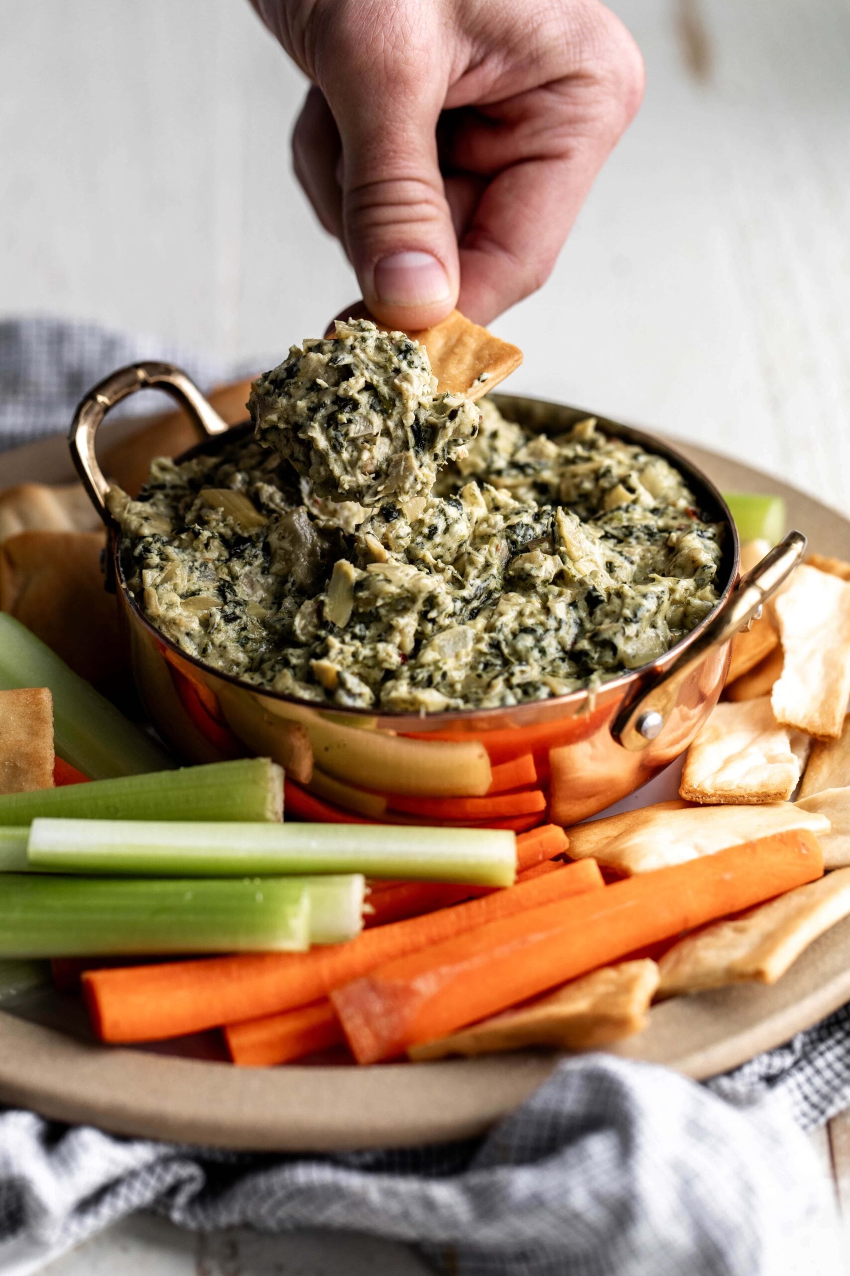 dipping pita chip in spinach artichoke dip top dips for super bowl.