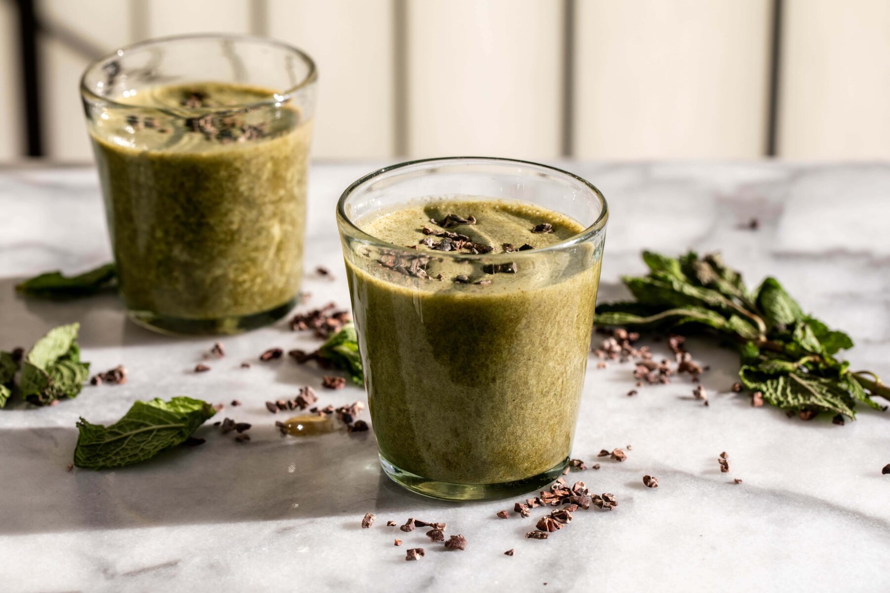 mint chocolate chip smoothie topped with cacao nibs.