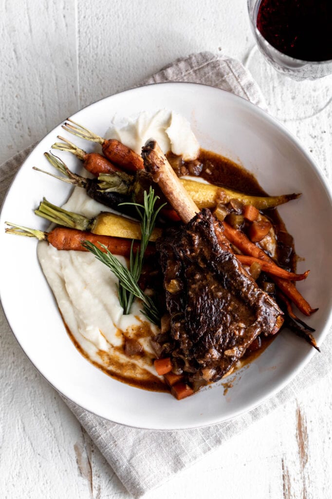red wine braised short ribs with carrots and celery root purée.