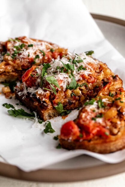 sausage and peppers toasts with parmesan cheese.