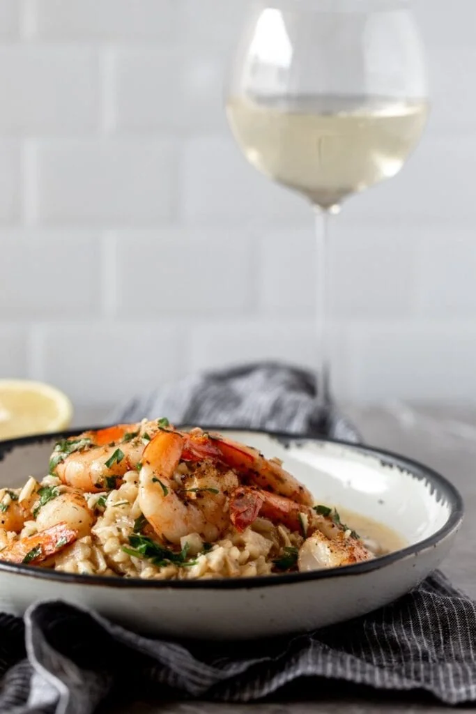 shrimp scampi risotto with white wine glass