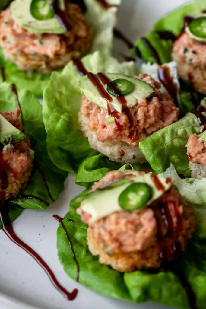 spicy tuna crispy rice served on butter lettuce cups with avocado, jalapeño slices and eel sauce