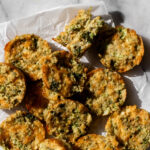 broccoli cheddar quinoa bites on parchment paper.
