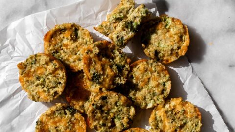broccoli cheddar quinoa bites on parchment paper.