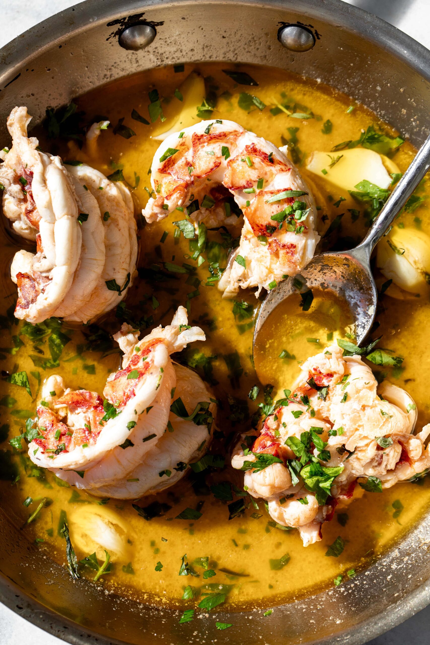 butter poached lobster tails with herbs.