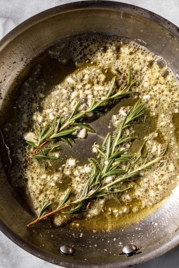 garlic and rosemary sprigs sautéed in butter.