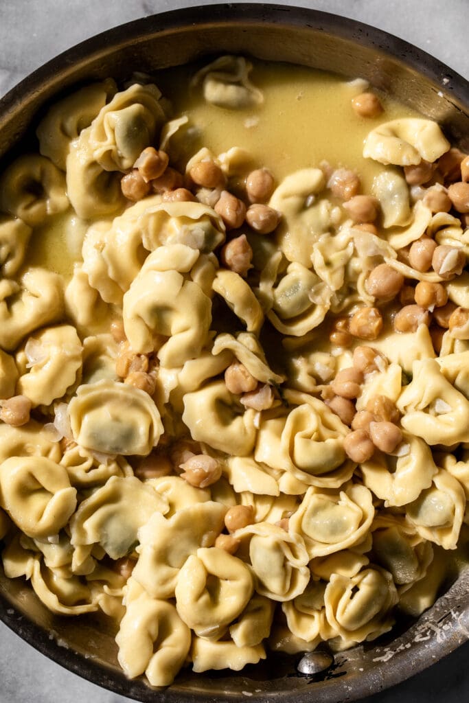  easy rosemary and chickpea tortellini pasta in sauté pan.