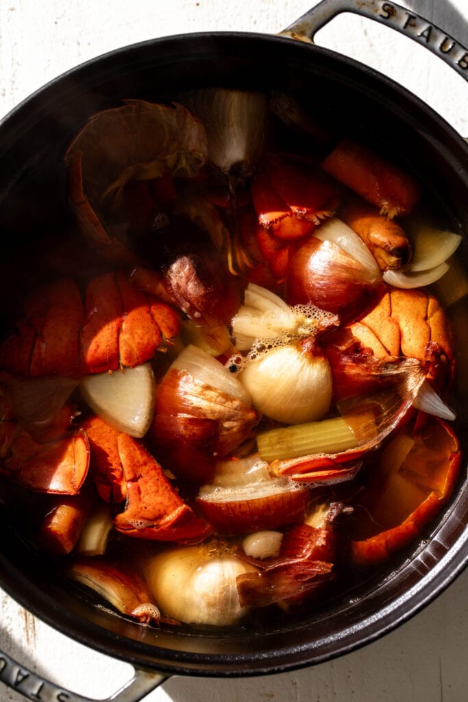 homemade lobster seafood stock simmered in pot.