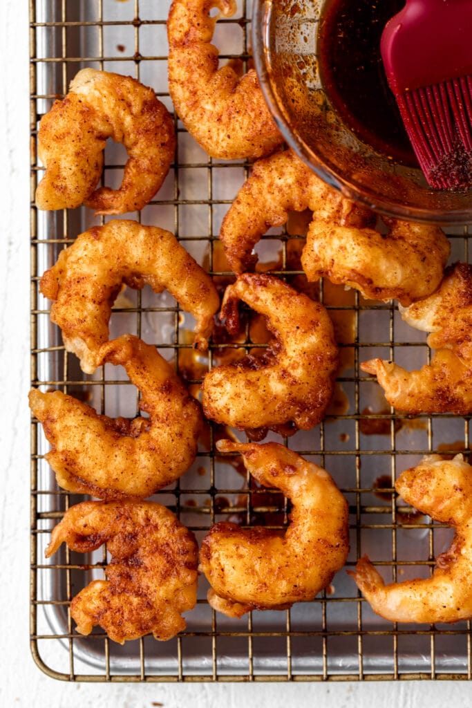 seasoned fried shrimp with nashville hot mixture.