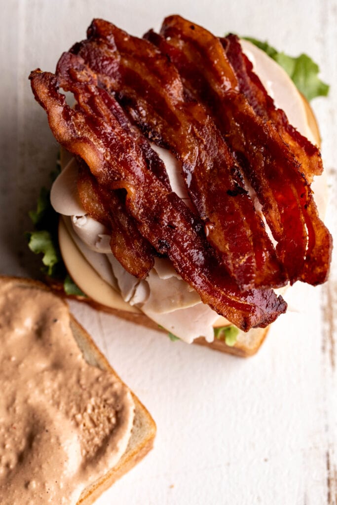 strips of bacon on assembled sandwich.