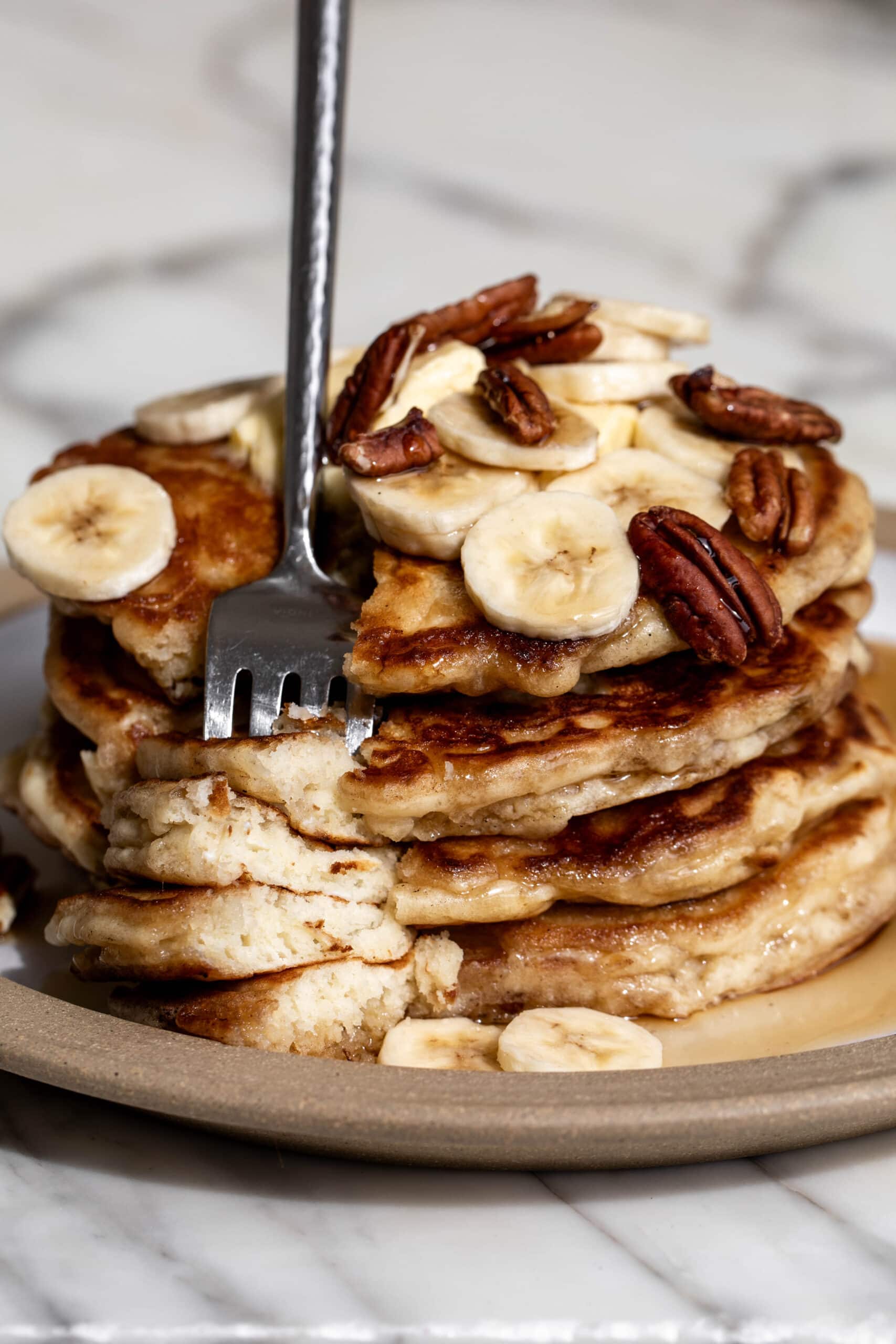 best banana pancakes with syrup and pecans.