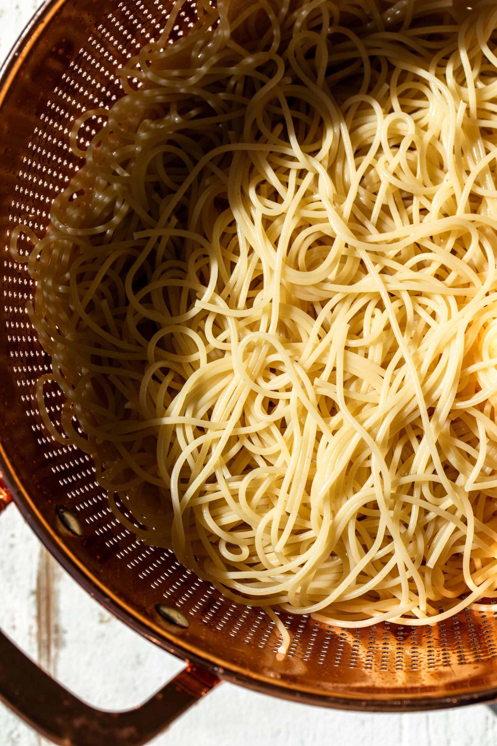 cold coriander noodles cashew in colander.