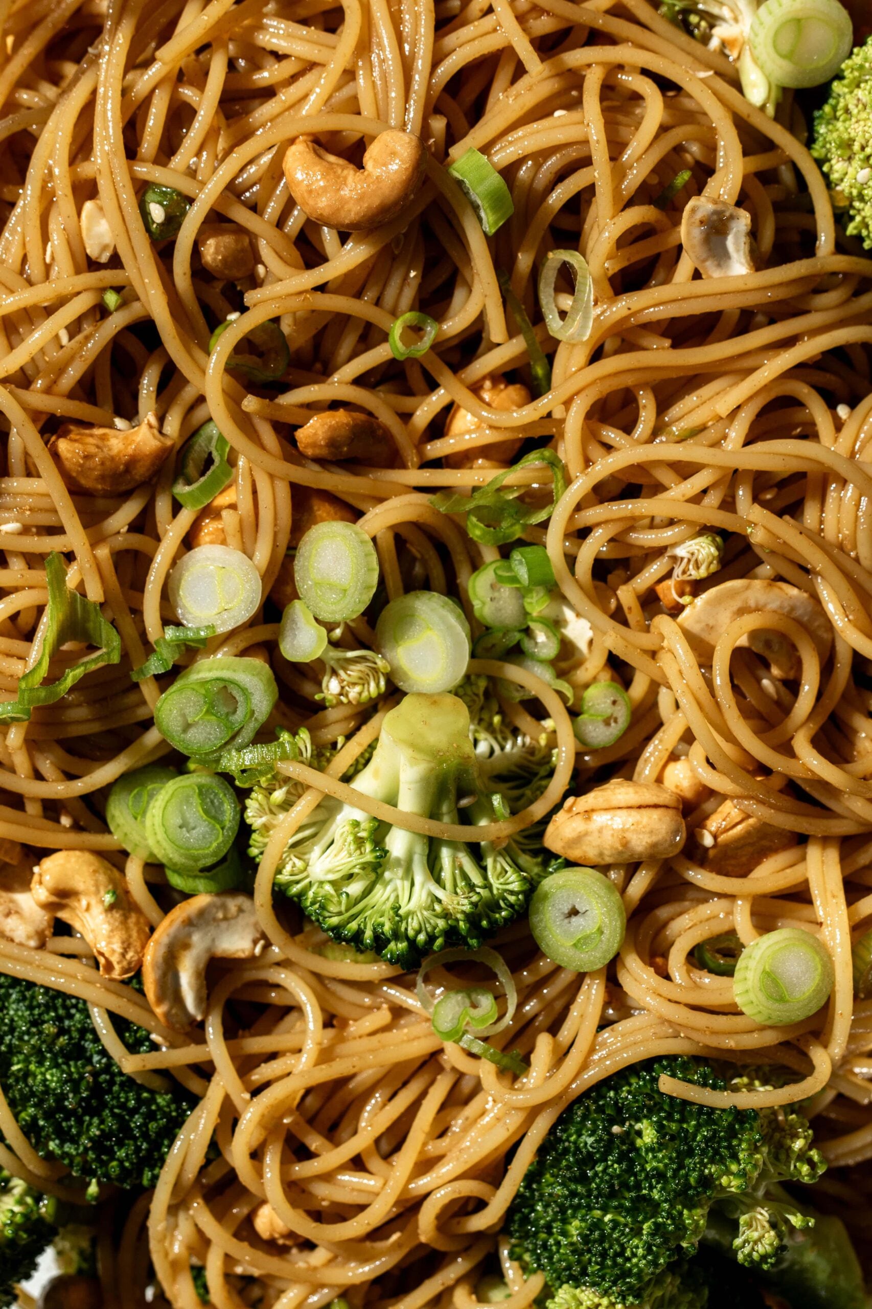 angel hair pasta in coriander sauce with cashews, broccoli and green onion.