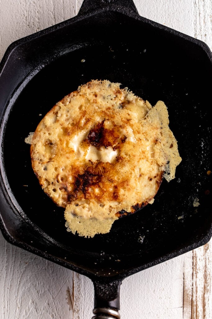 crispy swiss cheese melted on tortillas in cast iron pan.