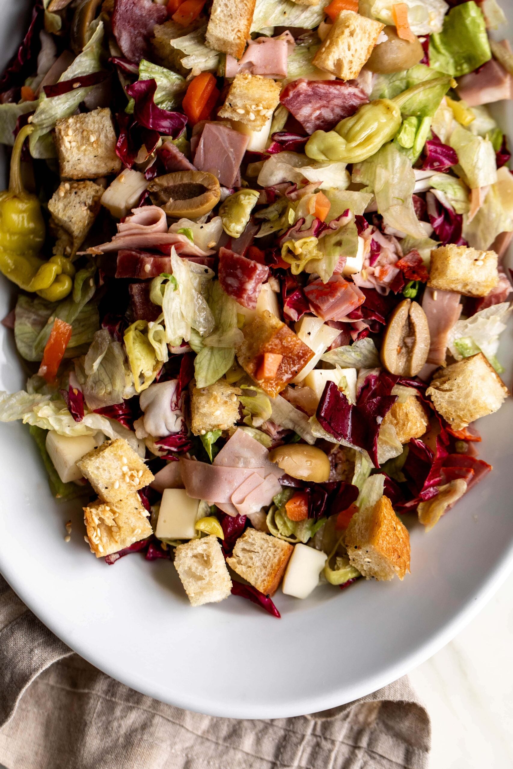 Muffaletta Salad with chopped deli meats and sesame croutons.
