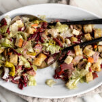 muffaletta salad recipe on white platter.