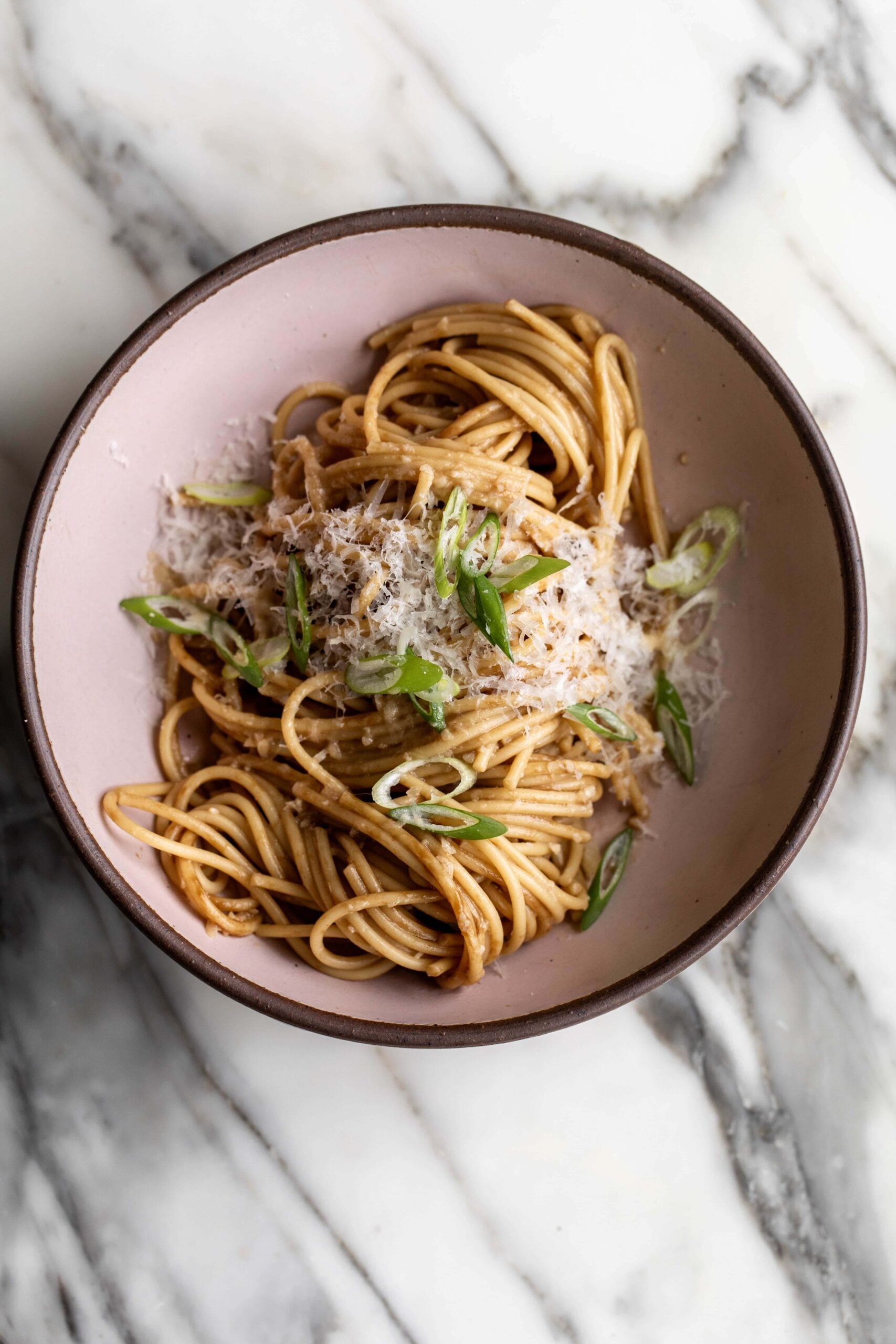 san francisco style vietnamese garlic noodles with grated Parmesan cheese and sliced green onion.