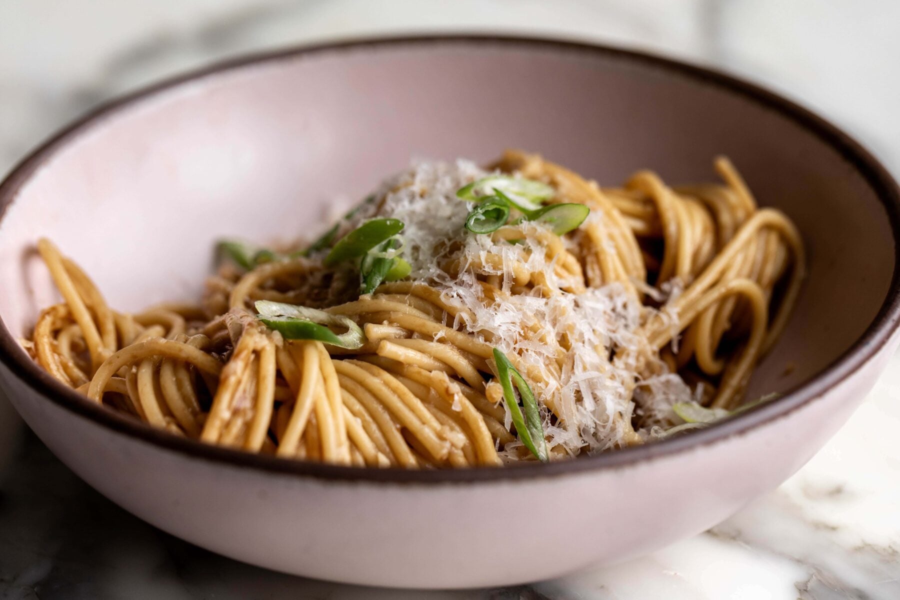 san francisco style vietnamese garlic noodles in pink stone bowl.