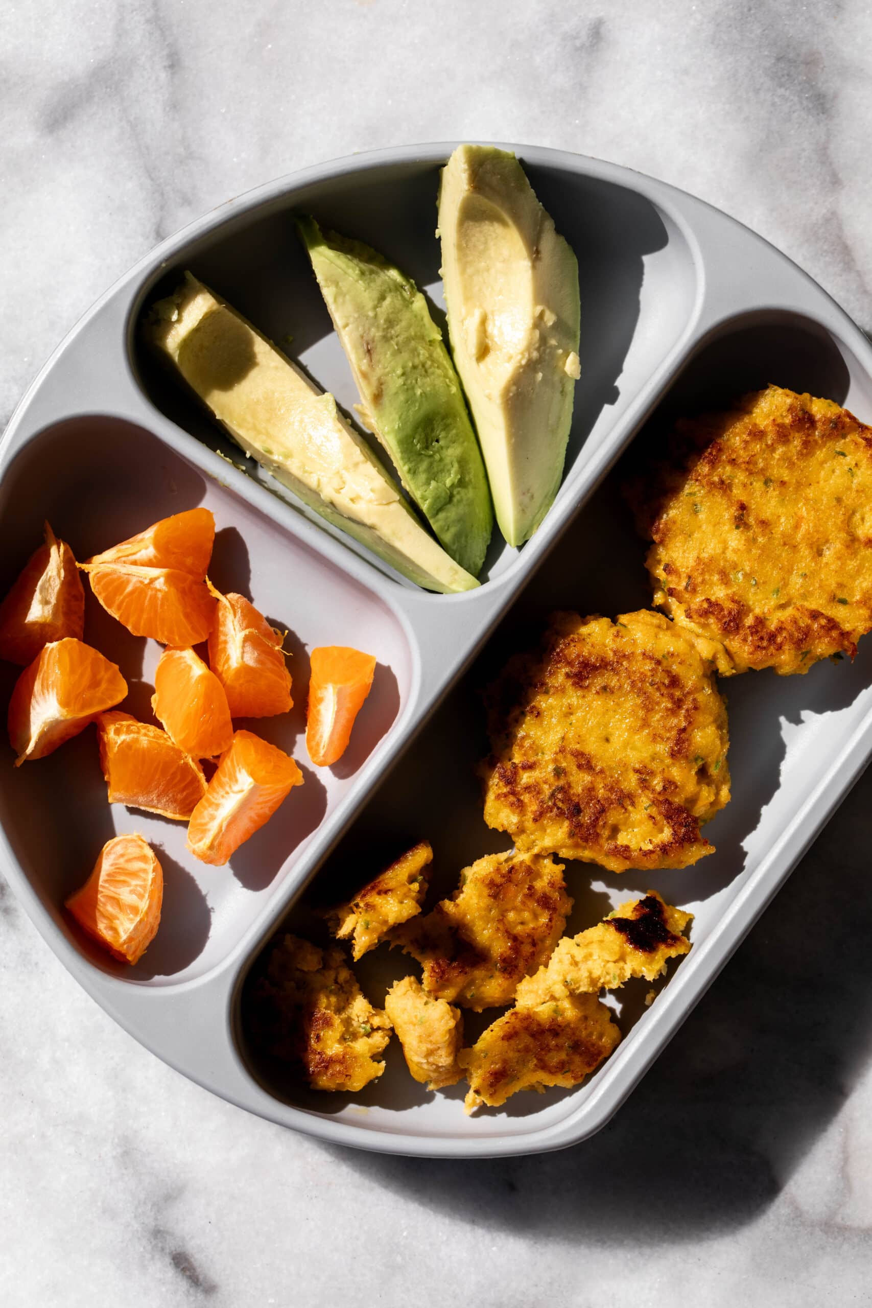 carrot shrimp cakes baby led weaning in rubber dish.