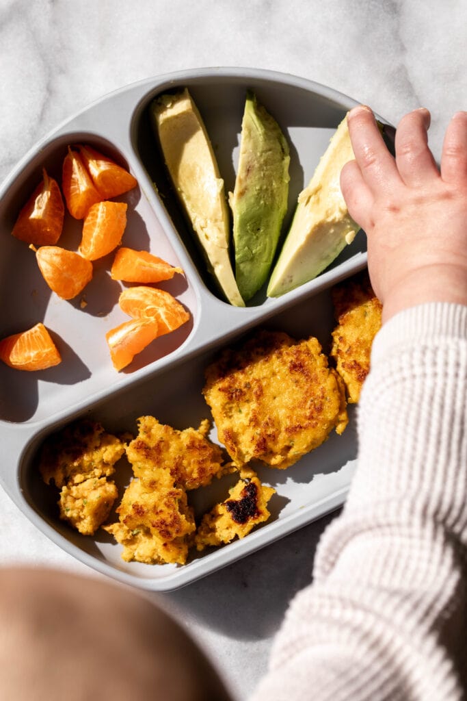 carrot shrimp cakes baby led weaning in rubber dish.