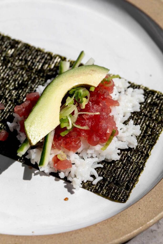 Chopped tuna with rice, green onion and avocado on nori.
