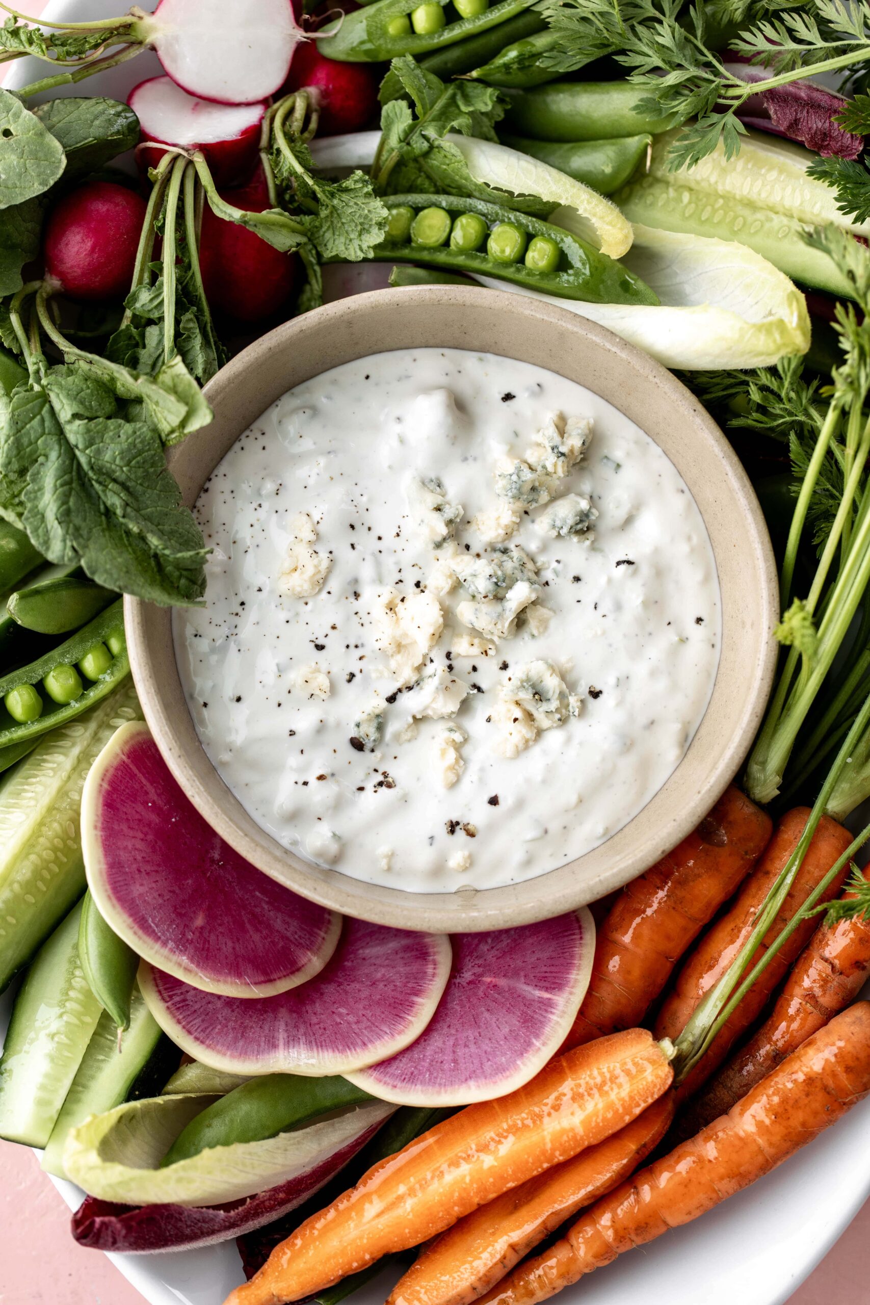 Top view of finished blue cheese dip with fresh vegetables for dipping.