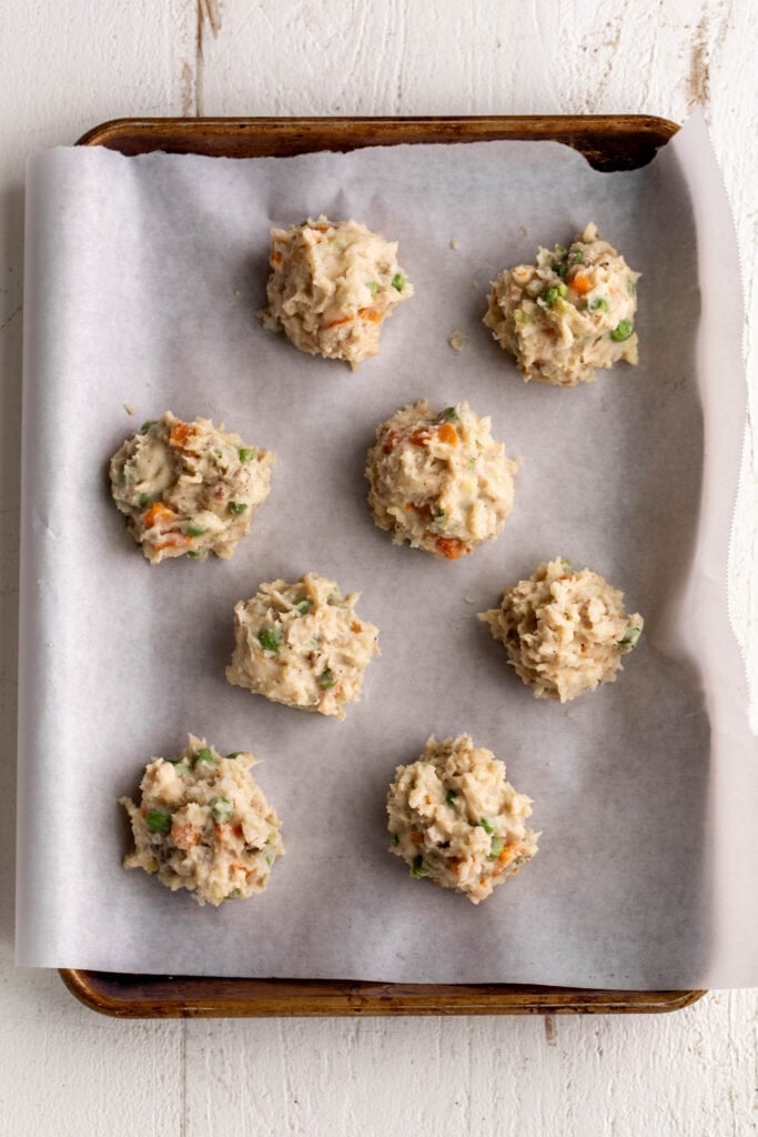 shaped croquettes on parchment paper-lined baking sheet.