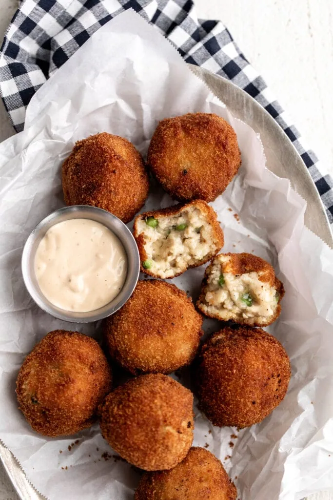 chicken pot pie croquettes broken open to show filling with aioli.
