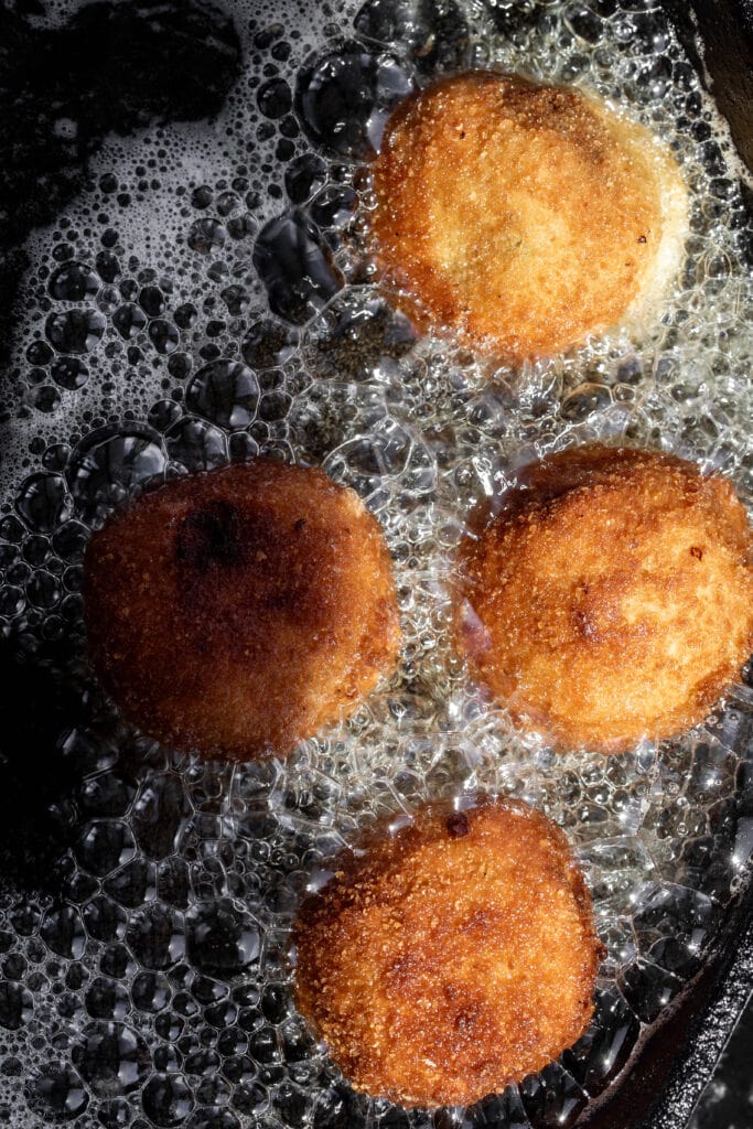 golden brown fried croquettes in hot oil.