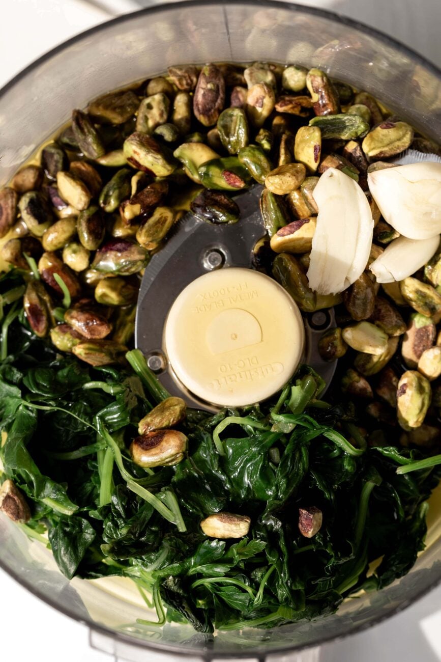 Ingredients for pistachio pesto ready for mixing in food processor.