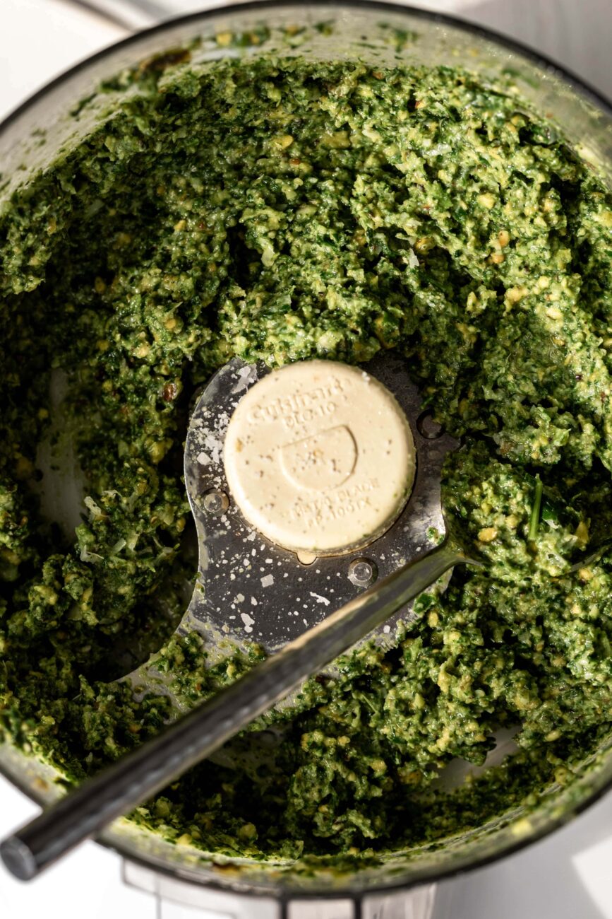Finished mixed ingredients for pistachio pesto in food processor.