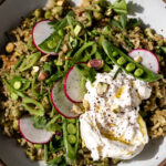Green spring rice pilaf with pistachio and pesto burrata ready for serving.