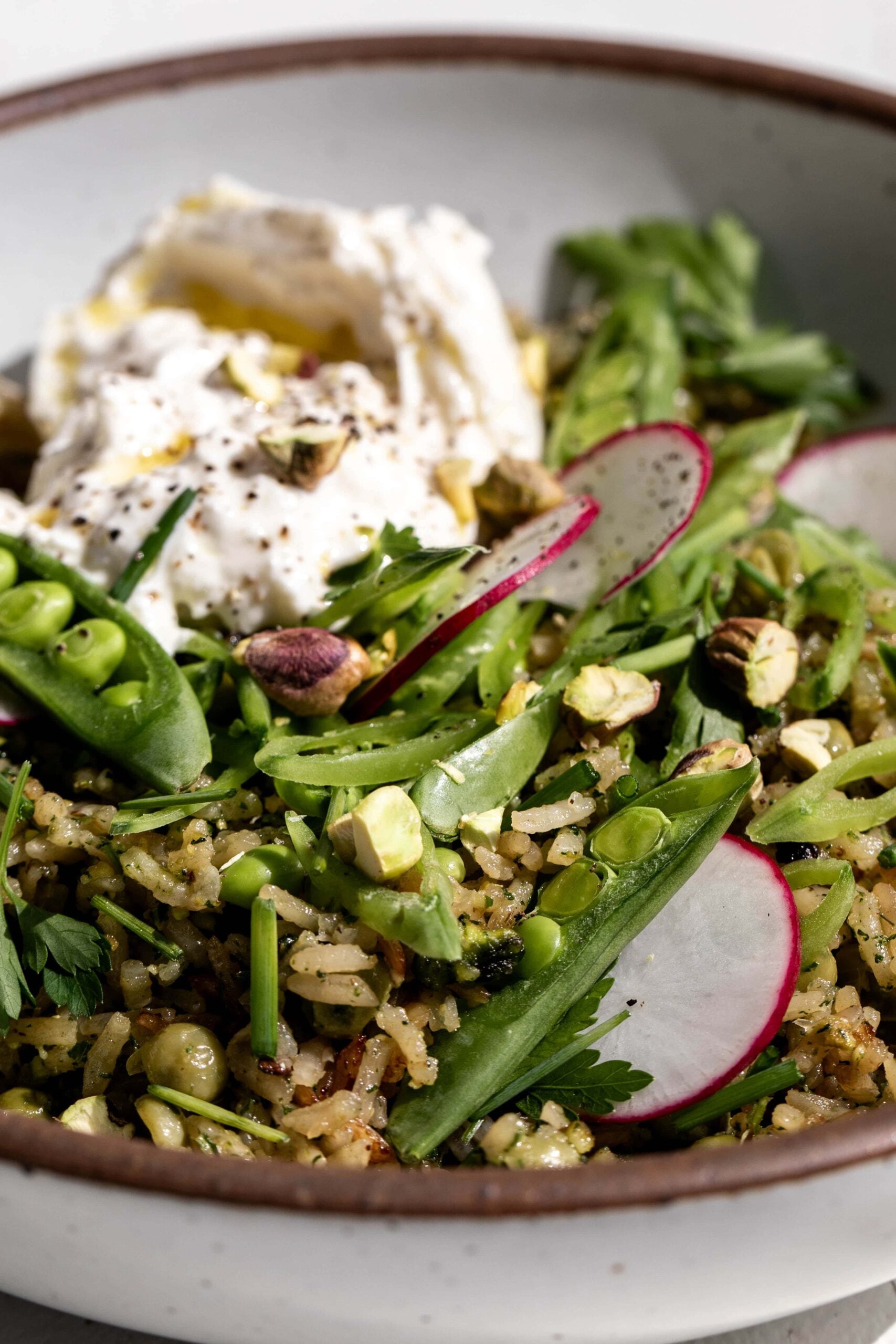 Close-up assembled Spring Rice Pilaf with Pistachio Pesto on plate.