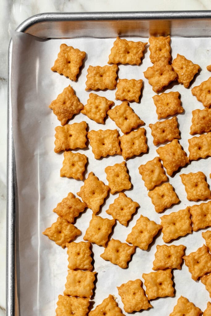 Homemade Cheez It Crackers on baking sheet.