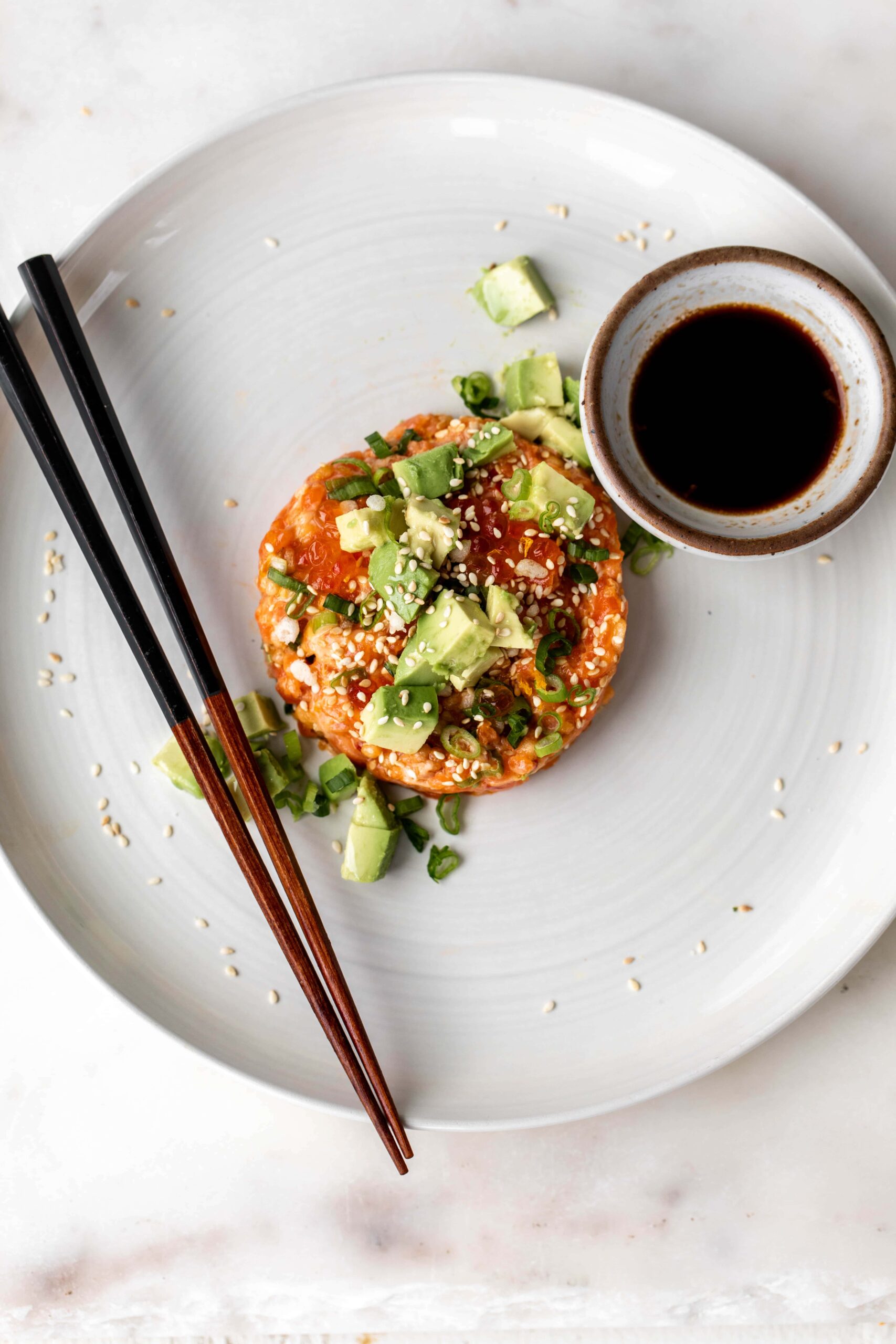 raw salmon tartare on white plate.