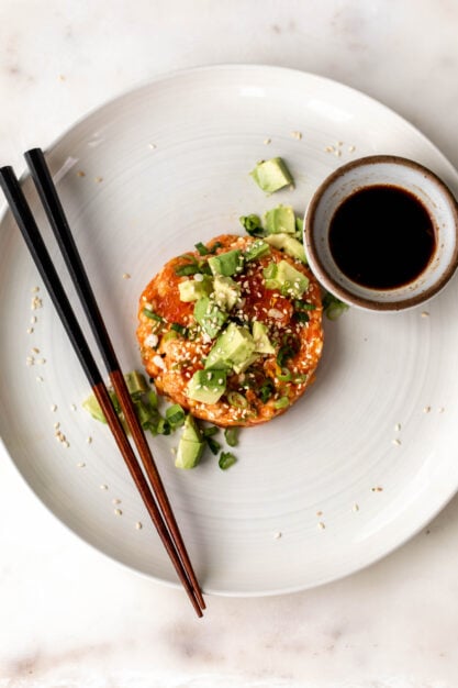 raw spicy salmon tartare with avocado and soy sauce.